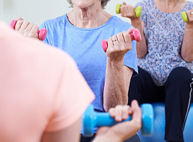 A group of elderly people exercising